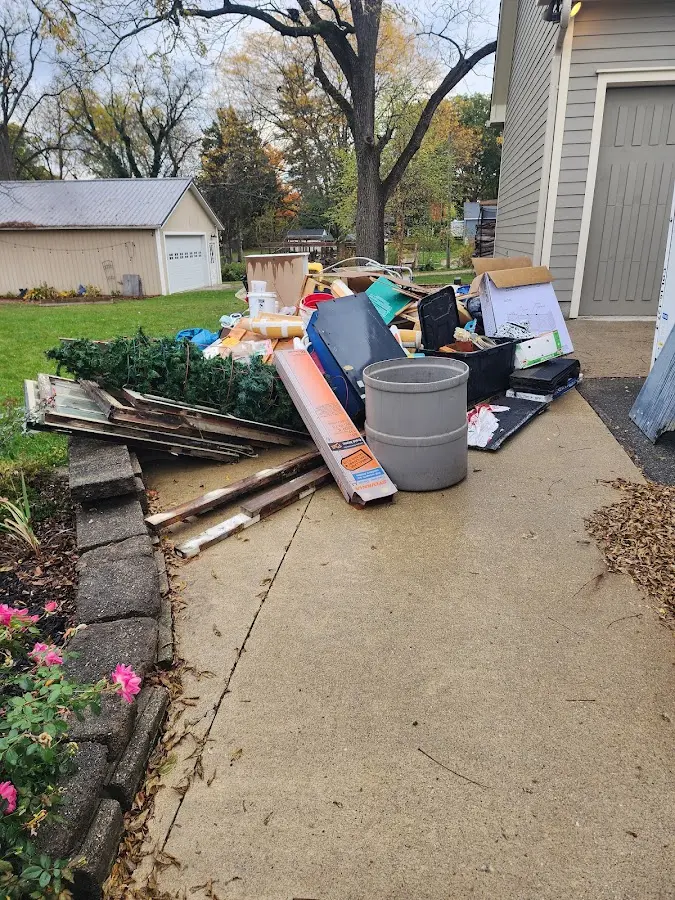 Dumpster being loaded with debris for Commercial Dumpster Rental in Athol